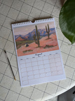 Calendar with a desert scene design on a tiled floor