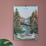 Wall calendar with nature design on a pink wall
